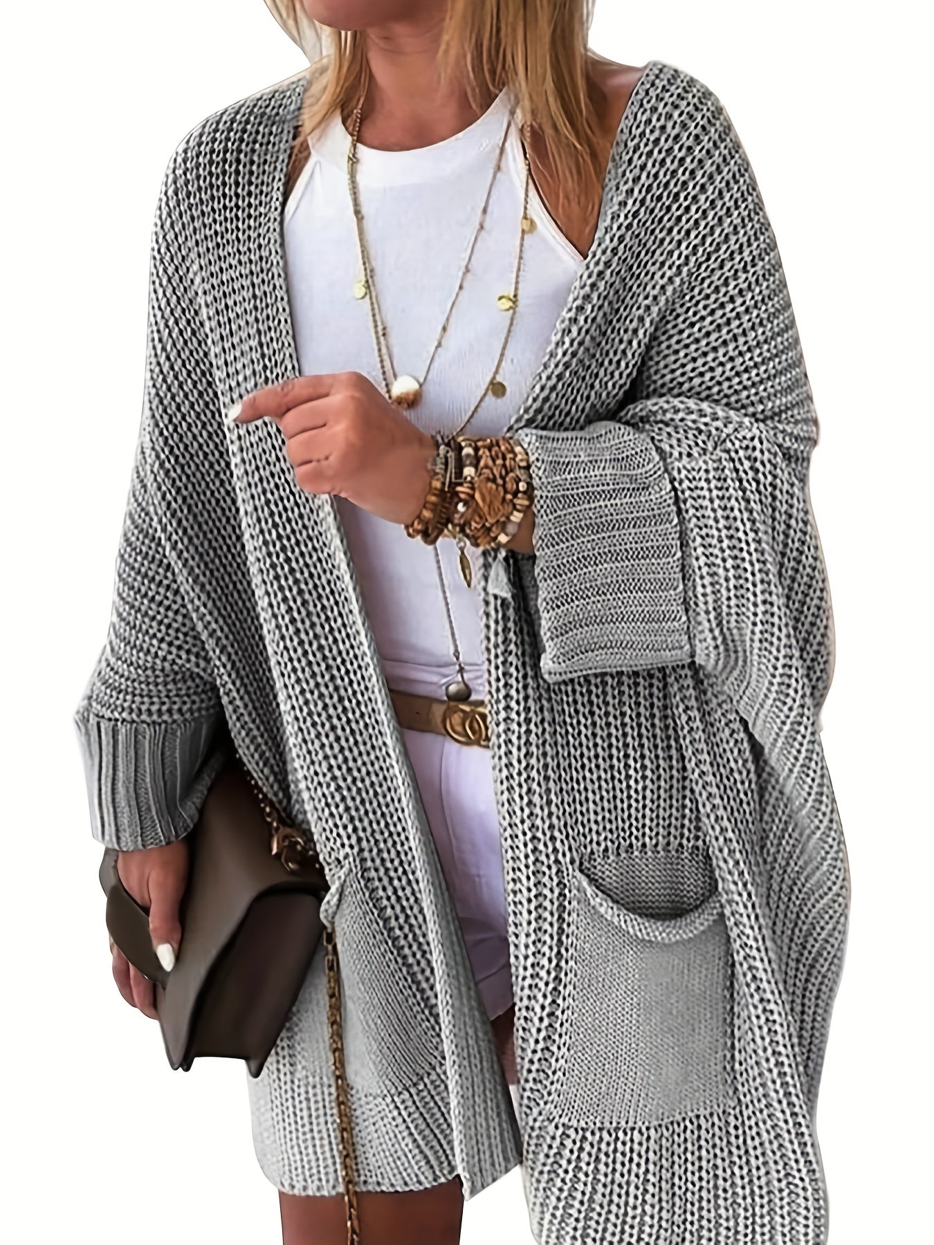 Stay warm and stylish this fall and winter with an elegant mid-length knit cardigan featuring convenient pockets.